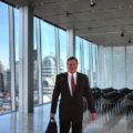 Businessman in suit overlooking city view.