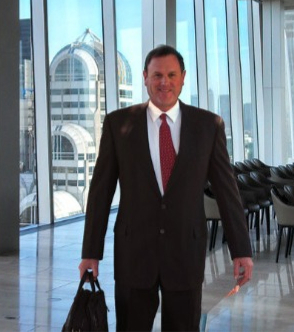 A man in suit and tie holding a bag