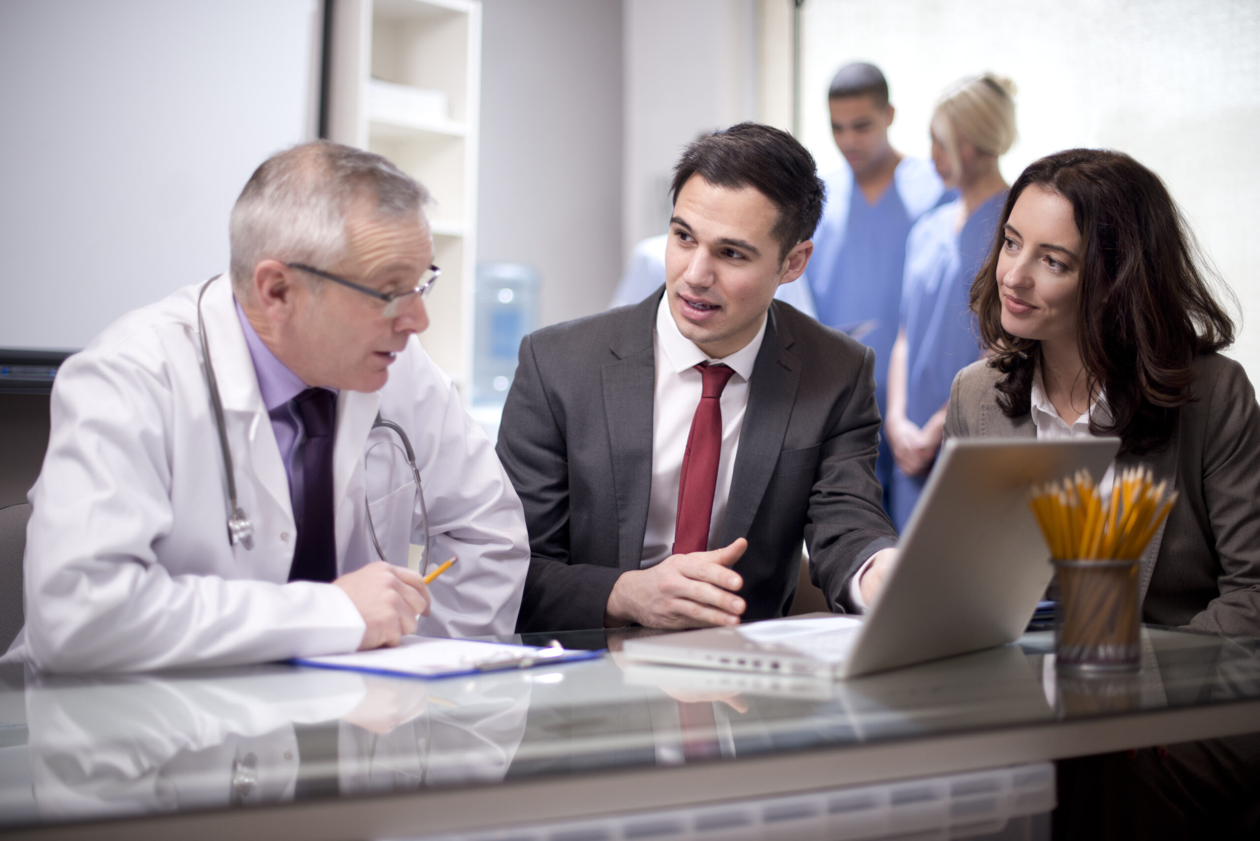 A group of doctors sitting around a table